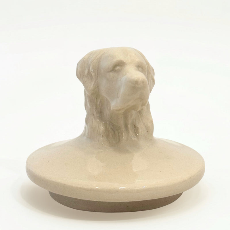 Close-up of hand-sculpted Retriever dog figure on ceramic urn lid