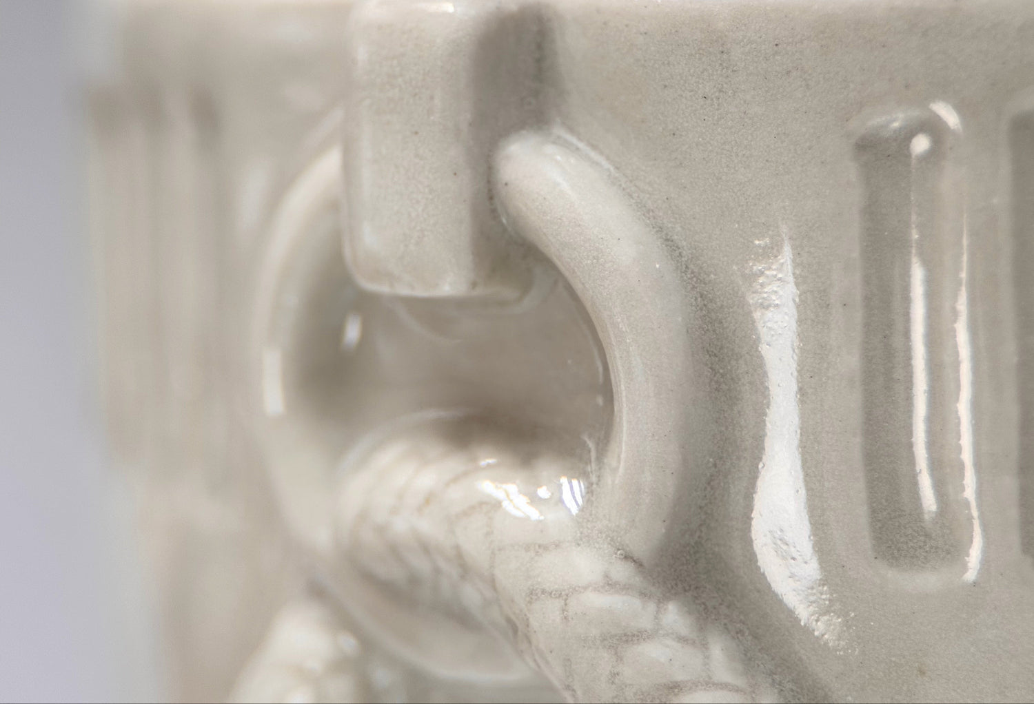 Close-up of collar ring detail on cream ceramic pet memorial urn