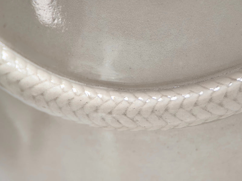 Close-up of draped rope relief detail on cream ceramic pet memorial urn