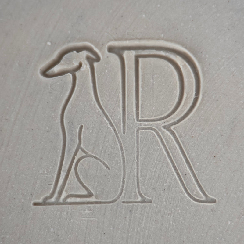 Remanē logo, stamped into bisque fired porcelain clay